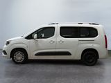 the white van is parked in a large room with a gray floor