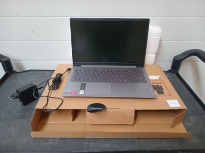 a laptop computer sitting on top of a cardboard box