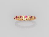 a gold ring with ruby stones