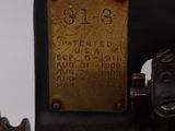 an old black sewing machine with a brass plate on it