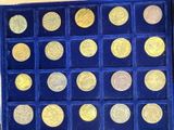 a blue box with gold coins in it on a table