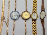 several different types of watches are displayed on a white surface
