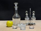 a bottle of liquor and a bowl of fruit on a table