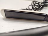 a cell phone sitting on top of a table next to a charger