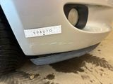 a sticker on the bumper of a white car