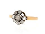 a close up of a gold and diamond ring on a white background