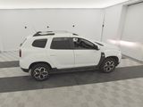 a picture of a white dacia parked in a garage