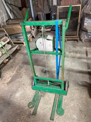 a green hand truck that is sitting in the garage