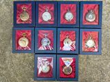 many different types of pocket watches displayed in a box