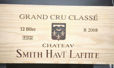une enseigne en bois sur laquelle on peut lire « Château Smith Hat Lafitte »