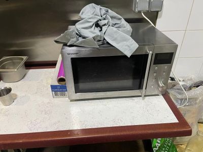 a microwave that is sitting on a counter in a kitchen