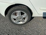 a white car with a flat tire on the road