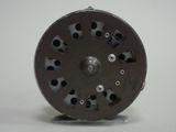 an image of a black and white photo of a fly reel
