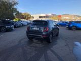 a black car parked in a parking lot next to other cars