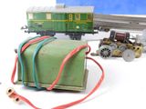 a toy train on the tracks and a box with wires