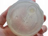a person holding a plastic object in their hand