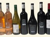 several bottles of wine are lined up in a row on a white background