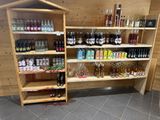 a wooden shelf filled with bottles and bottles of alcohol