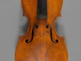an old violin with a bow on a gray background
