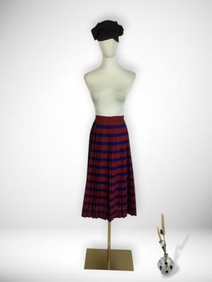 purple and red plaid skirt on a mannequin stand with a guitar