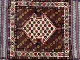 an antique persian rug with a geometric design