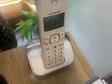 a cell phone sitting on top of a wooden table