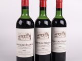 trois bouteilles de vin rouge sont alignées sur une surface blanche