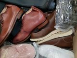many pairs of shoes in a box on the floor