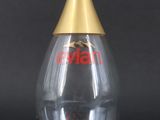 a clear glass bottle with a gold top and a gold cap