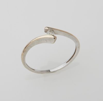 a white gold ring with a diamond set in the middle