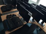 two computer monitors and a keyboard on the desk
