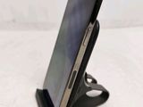 a close up of a cell phone on a stand on a table