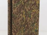 an old book with a brown cover and a green and yellow design
