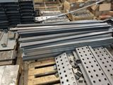 many pieces of metal sitting on a pallet in a warehouse