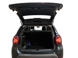 the back of a car with its trunk open and luggage in the trunk