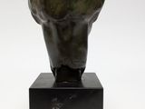 a bronze head of a man on a black base
