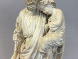 an image of a statue of a man holding a child