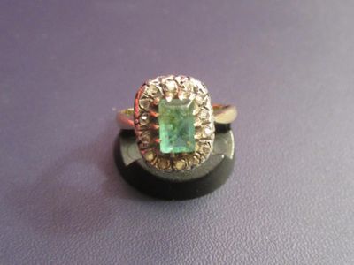 an image of a ring with a green stone in it