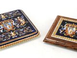 two coasters with decorative designs on them on a white surface