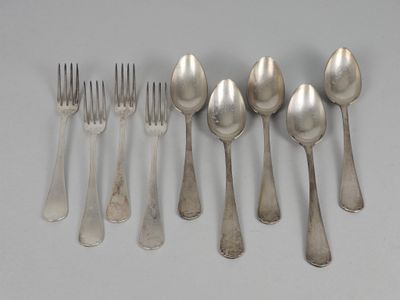five spoons and six forks on the table