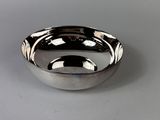 a silver bowl that is sitting on a table