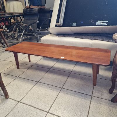 a coffee table with a tv on top of it