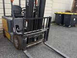 a fork lift truck that is parked in front of a building