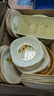 many plates and bowls in a box on the table