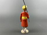 toy figurine of a man in a red outfit holding a sword