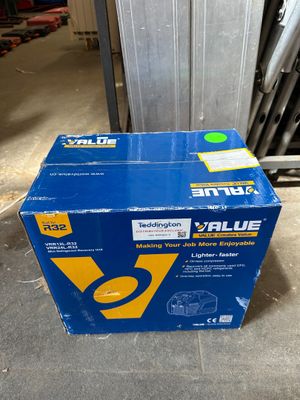 a blue box sitting on top of a floor next to a wall