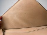 the inside of a beige purse with a zipper on it