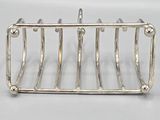 a silver plated toaster that has been placed on a table