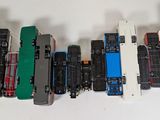 several toy trains are lined up in a row on a white surface