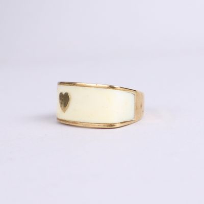 a close up of a gold ring with a heart on it